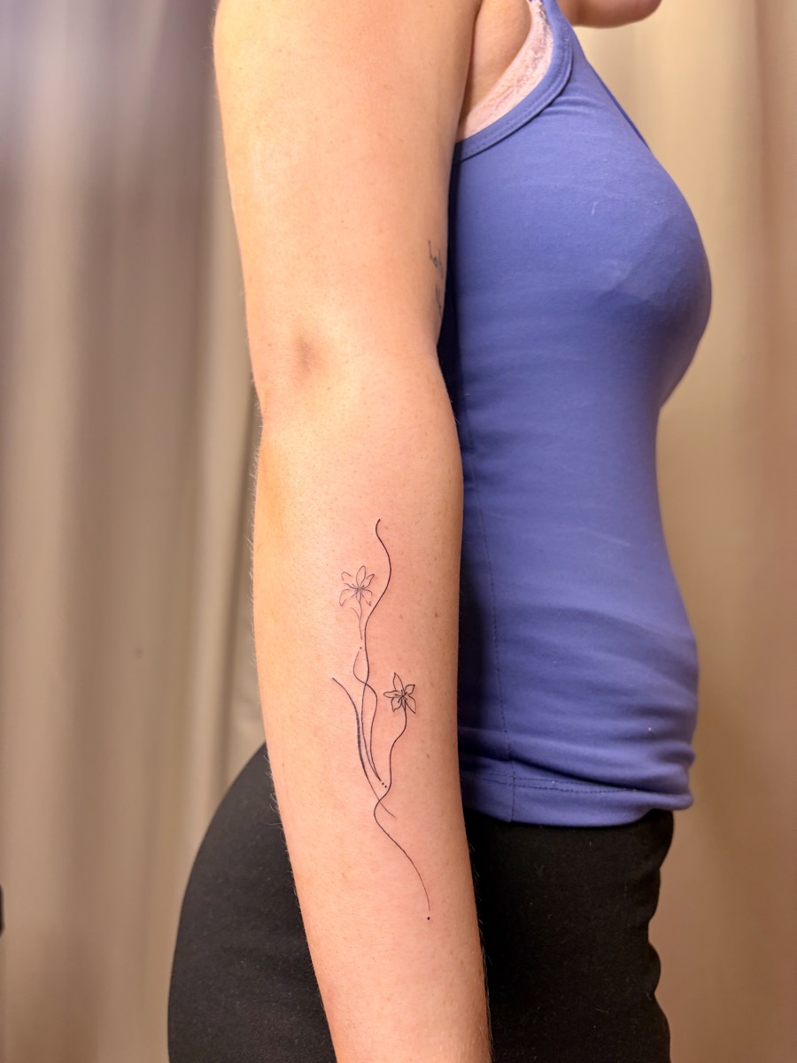 Feminine fine line floral tattoo on arm Perth